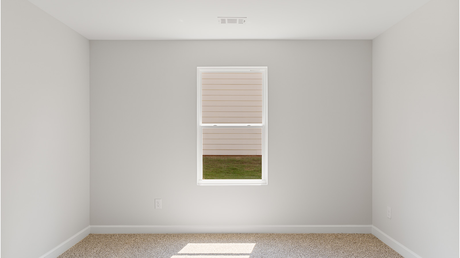 Comfortable guest bedroom with soft carpet and a spacious closet.
