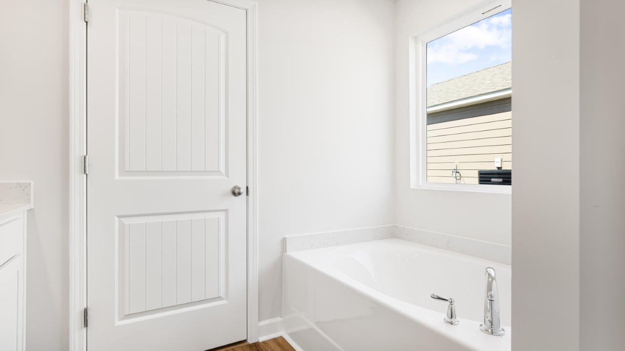 Belfort floorplan with quartz counter tops,, open concept living, and lvp flooring in all wet areas