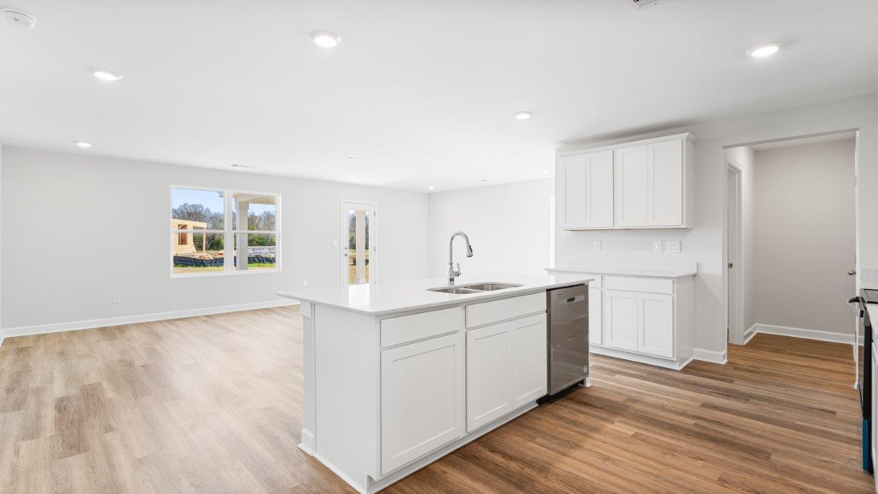 Belfort floorplan with quartz counter tops,, open concept living, and lvp flooring in all wet areas