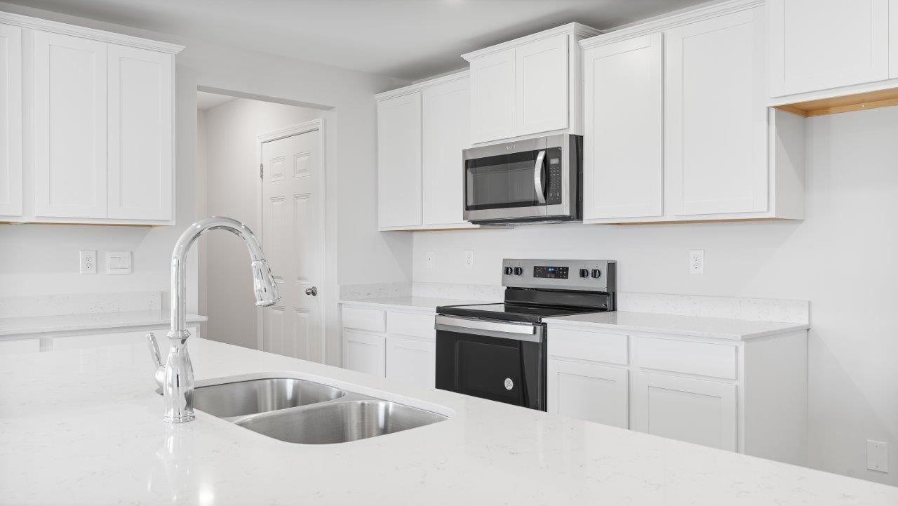 Belfort floorplan with quartz counter tops,, open concept living, and lvp flooring in all wet areas