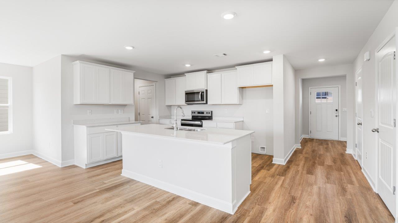 Belfort floorplan with quartz counter tops,, open concept living, and lvp flooring in all wet areas