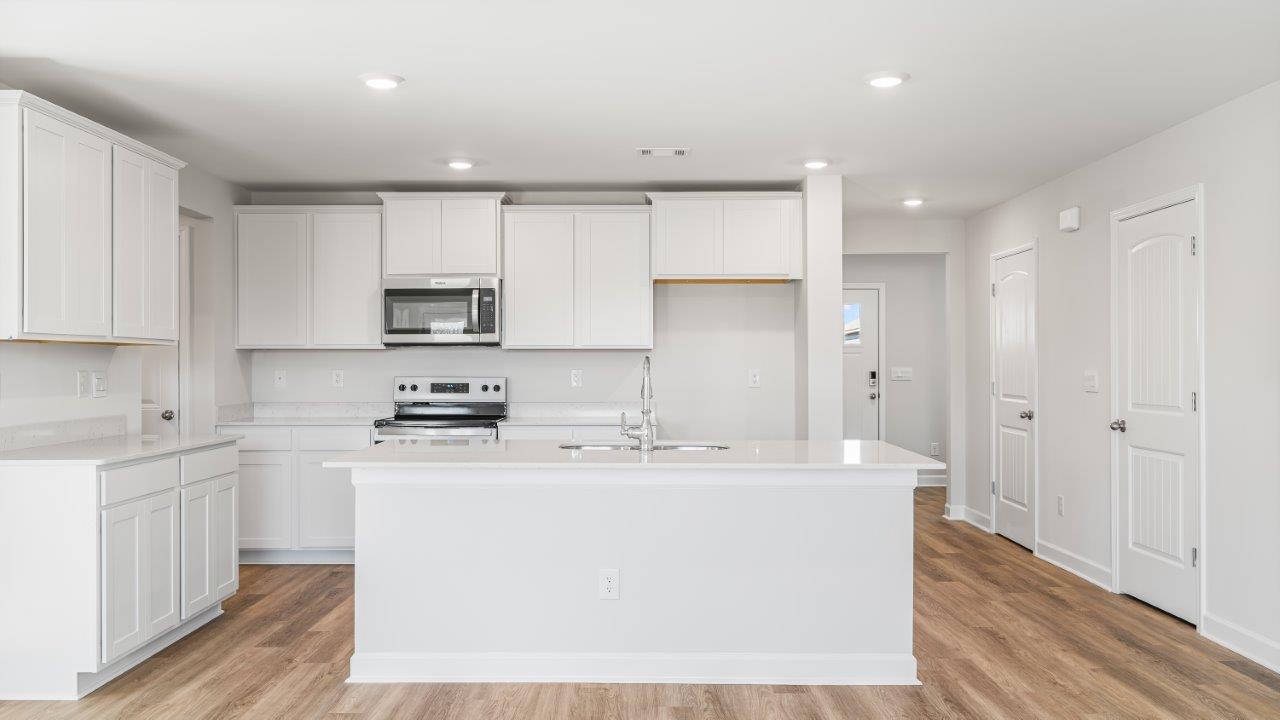 Belfort floorplan with quartz counter tops,, open concept living, and lvp flooring in all wet areas