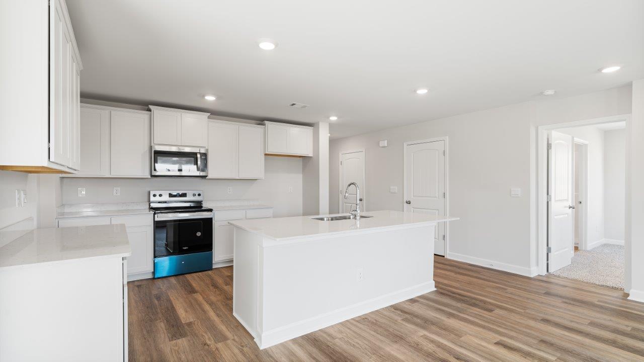 Belfort floorplan with quartz counter tops,, open concept living, and lvp flooring in all wet areas