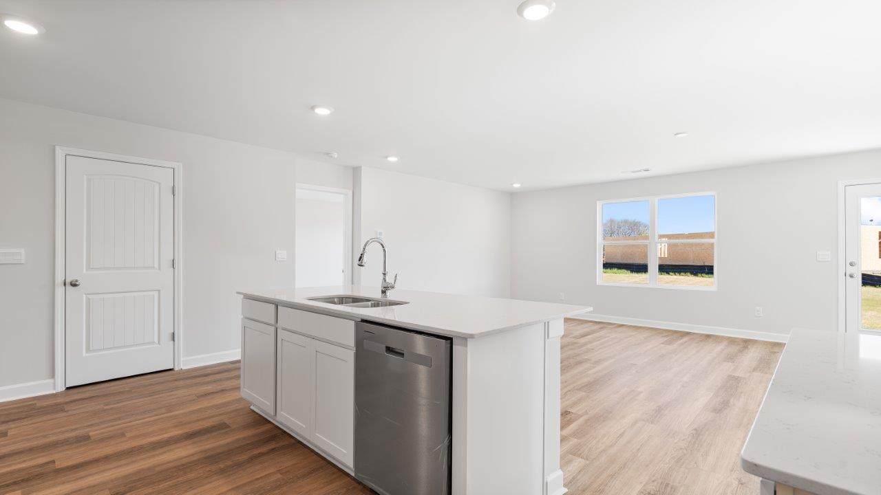 Belfort floorplan with quartz counter tops,, open concept living, and lvp flooring in all wet areas