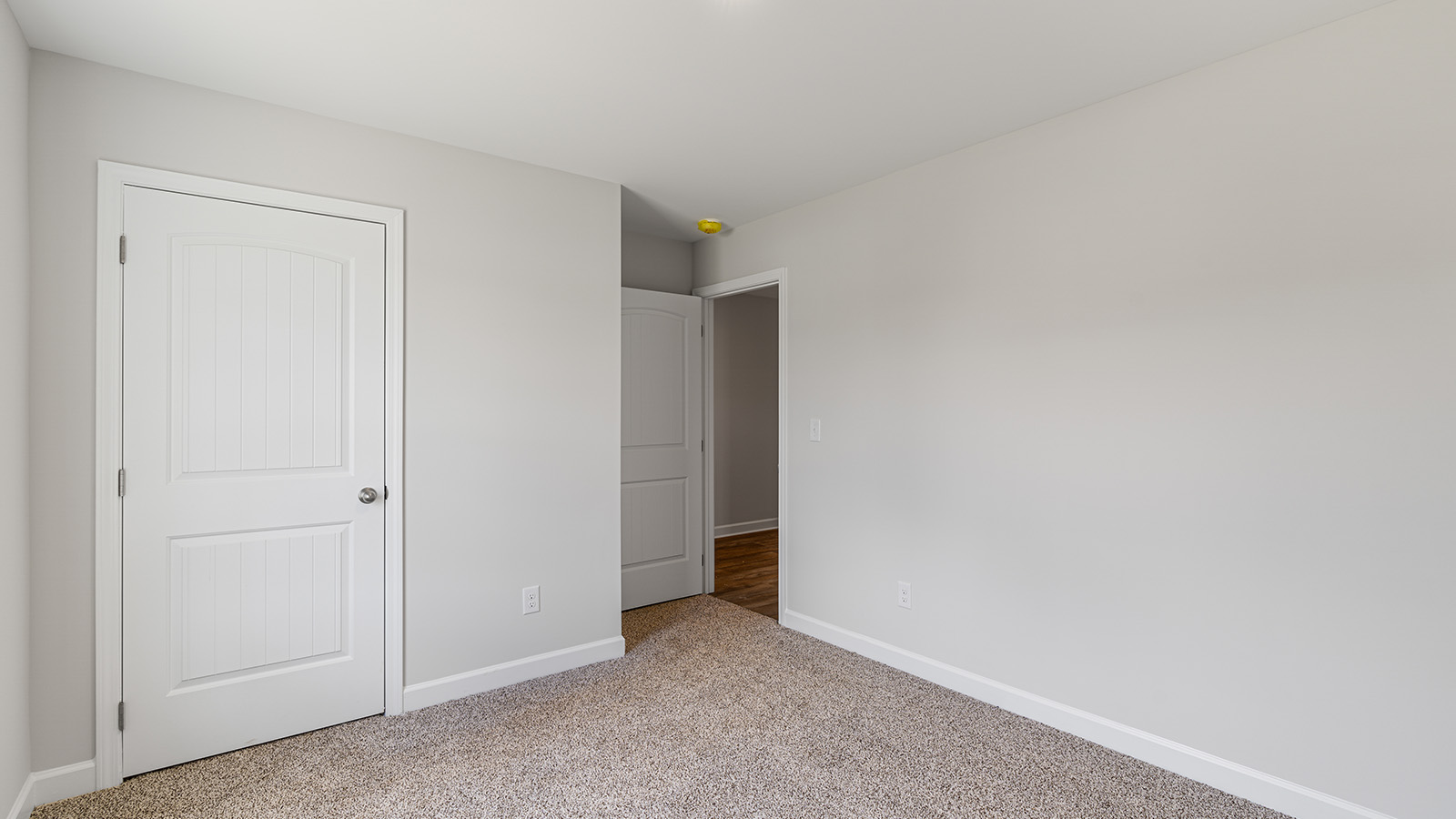 Interior photo of a bedroom in a freeport floorplan home.