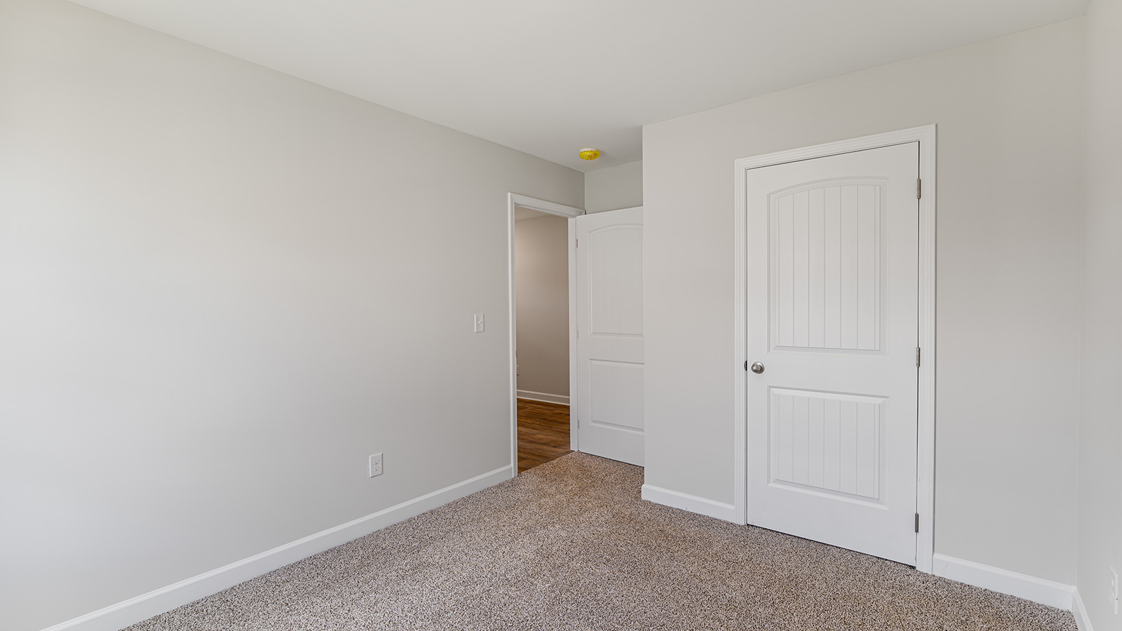 Interior photo of a bedroom in a freeport floorplan home.