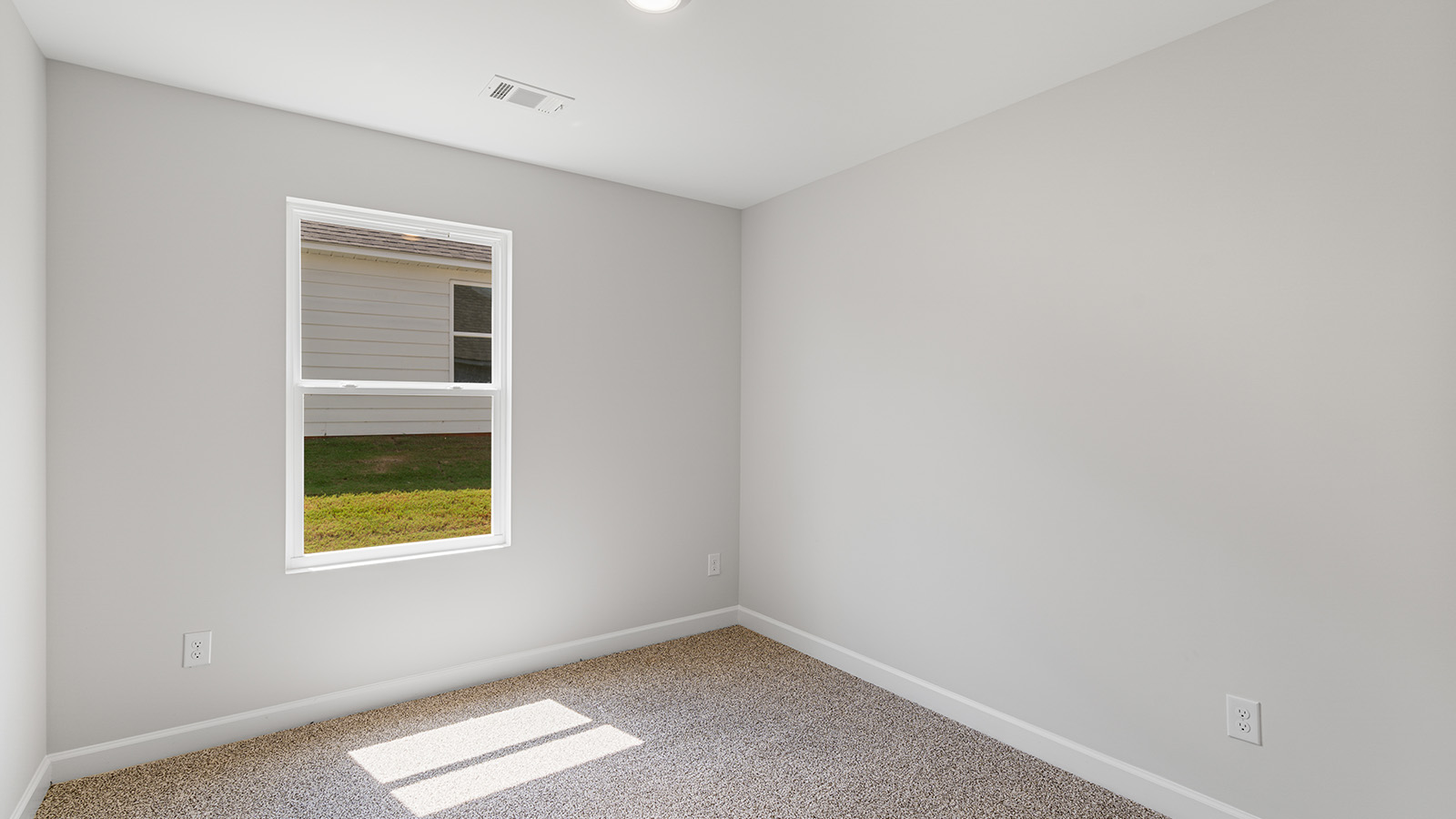 Interior photo of a bedroom in a freeport floorplan home.