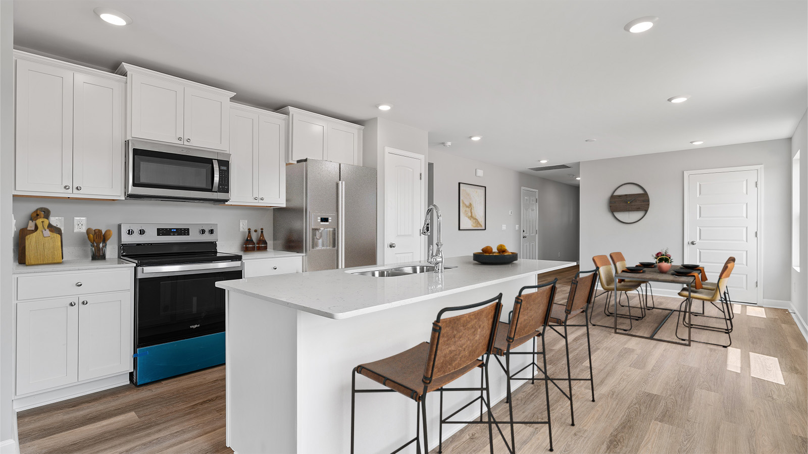 luxury vinyl plank flooring in kitchen with stainless steel appliances and Quartz countertops with soft close cabinets