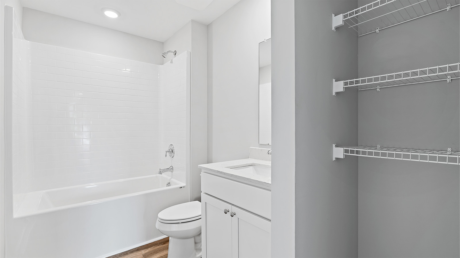 luxury vinyl plan flooring in bathrooms with quartz countertops