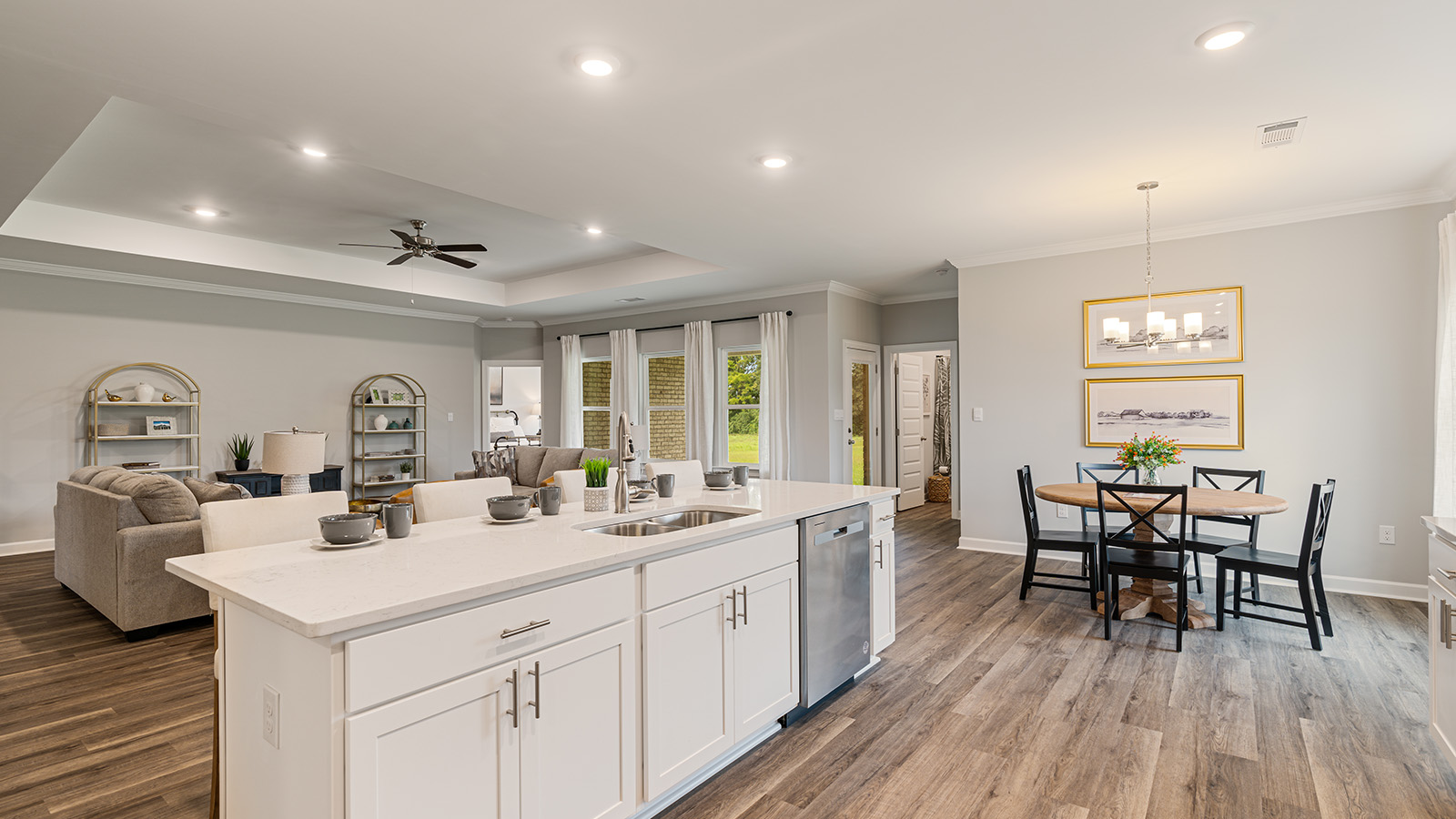 luxury vinyl plank flooring in kitchen with stainless steel appliances and Quartz countertops with soft close cabinets
