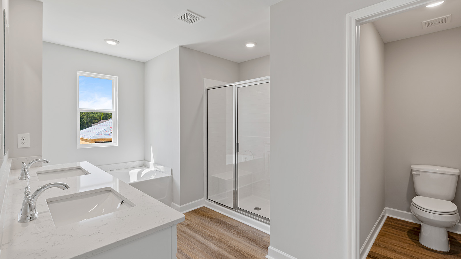 luxury vinyl plan flooring in bathrooms with quartz countertops