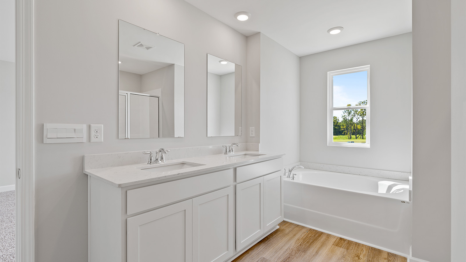 luxury vinyl plan flooring in bathrooms with quartz countertops