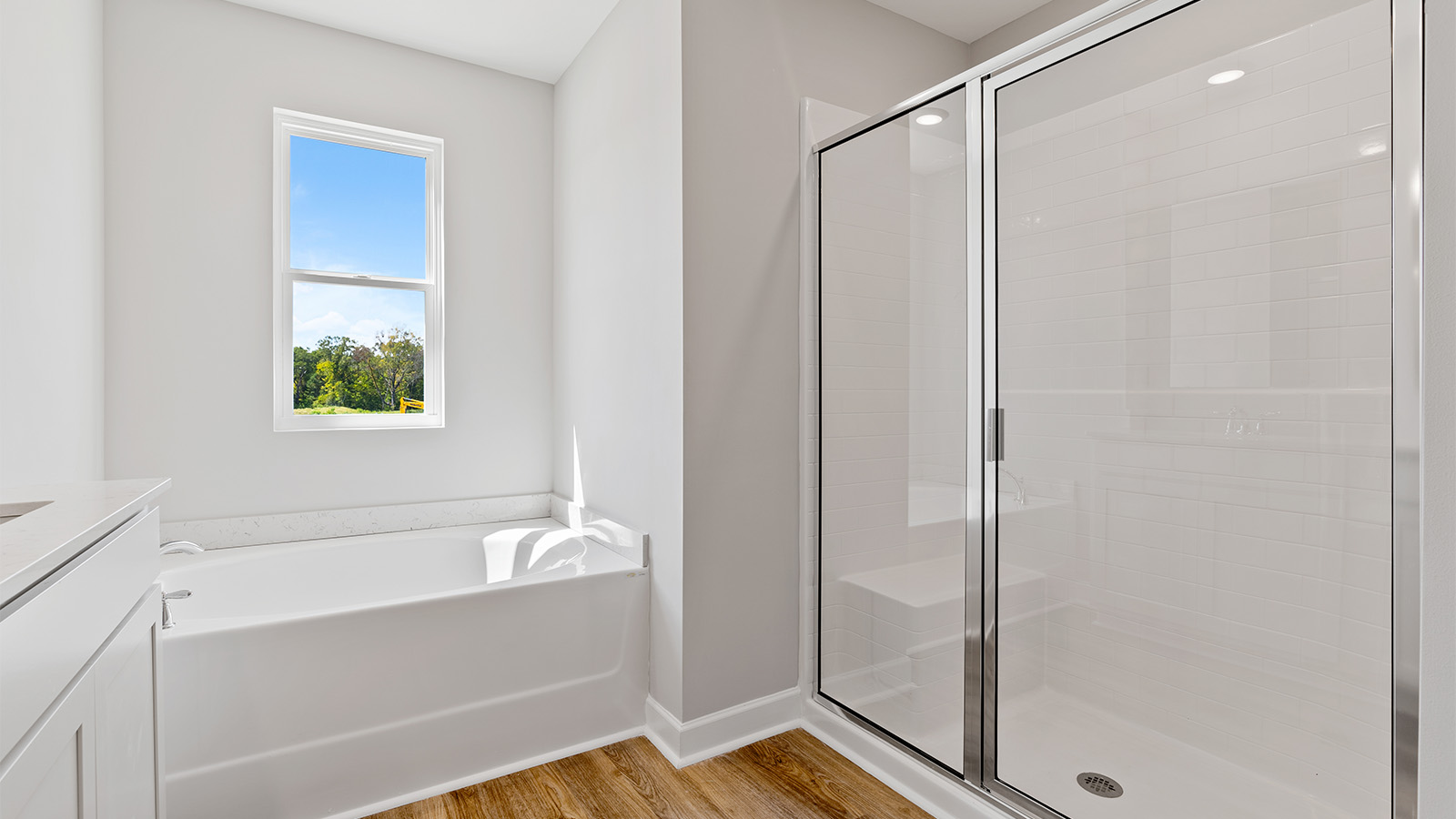luxury vinyl plan flooring in bathrooms with quartz countertops