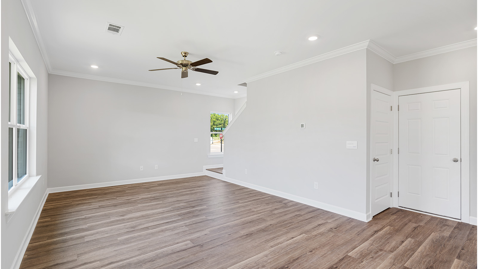 luxury vinyl plank flooring in kitchen with stainless steel appliances and Quartz countertops with soft close cabinets
