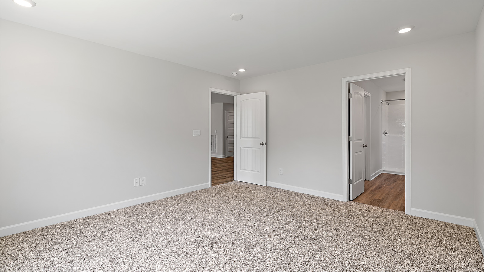 Large primary suite with walk in closet and private bath