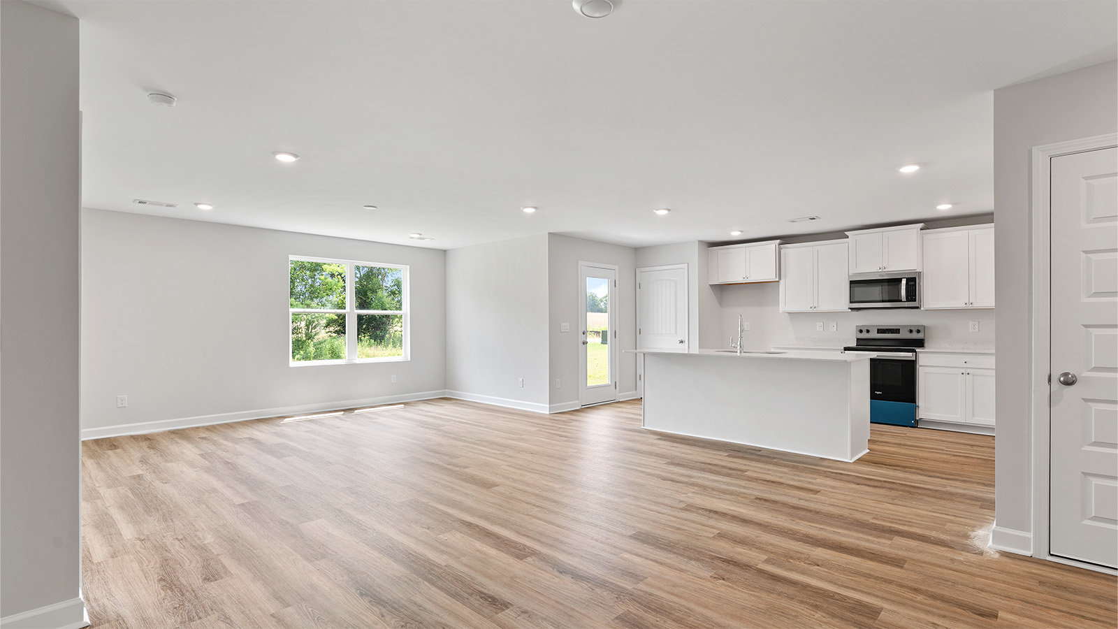 Seamless kitchen to living flow with luxury vinyl plank floors
