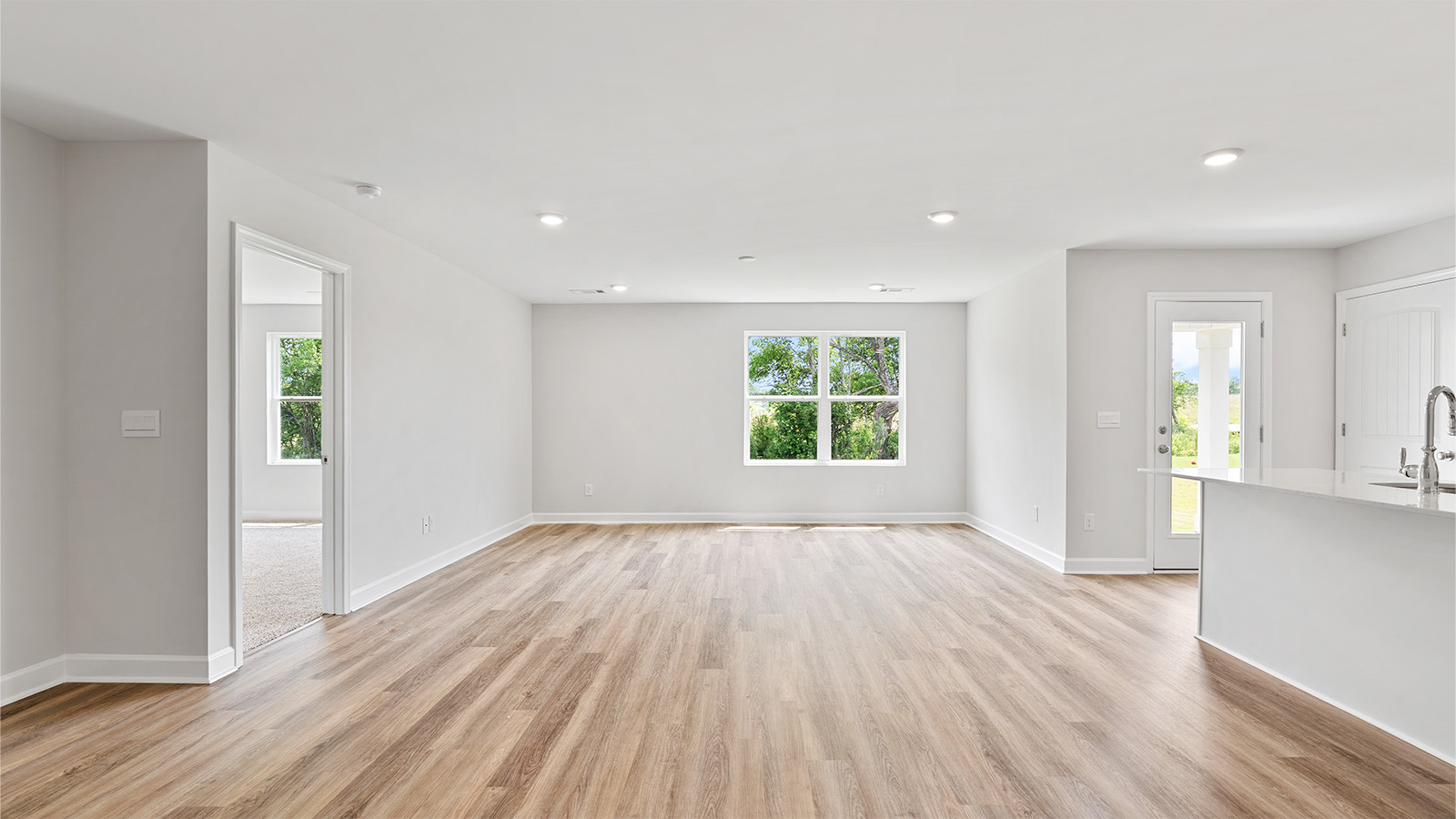 Seamless kitchen to living flow with luxury vinyl plank floors