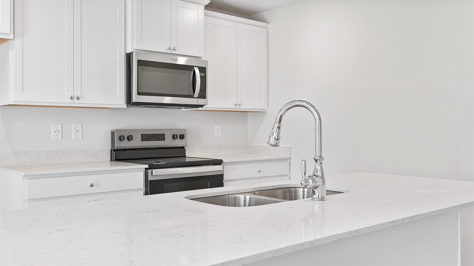 luxury vinyl plank flooring in kitchen with stainless steel appliances and Quartz countertops with soft close cabinets