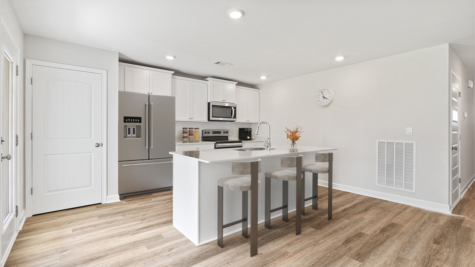 luxury vinyl plank flooring in kitchen with stainless steel appliances and Quartz countertops with soft close cabinets