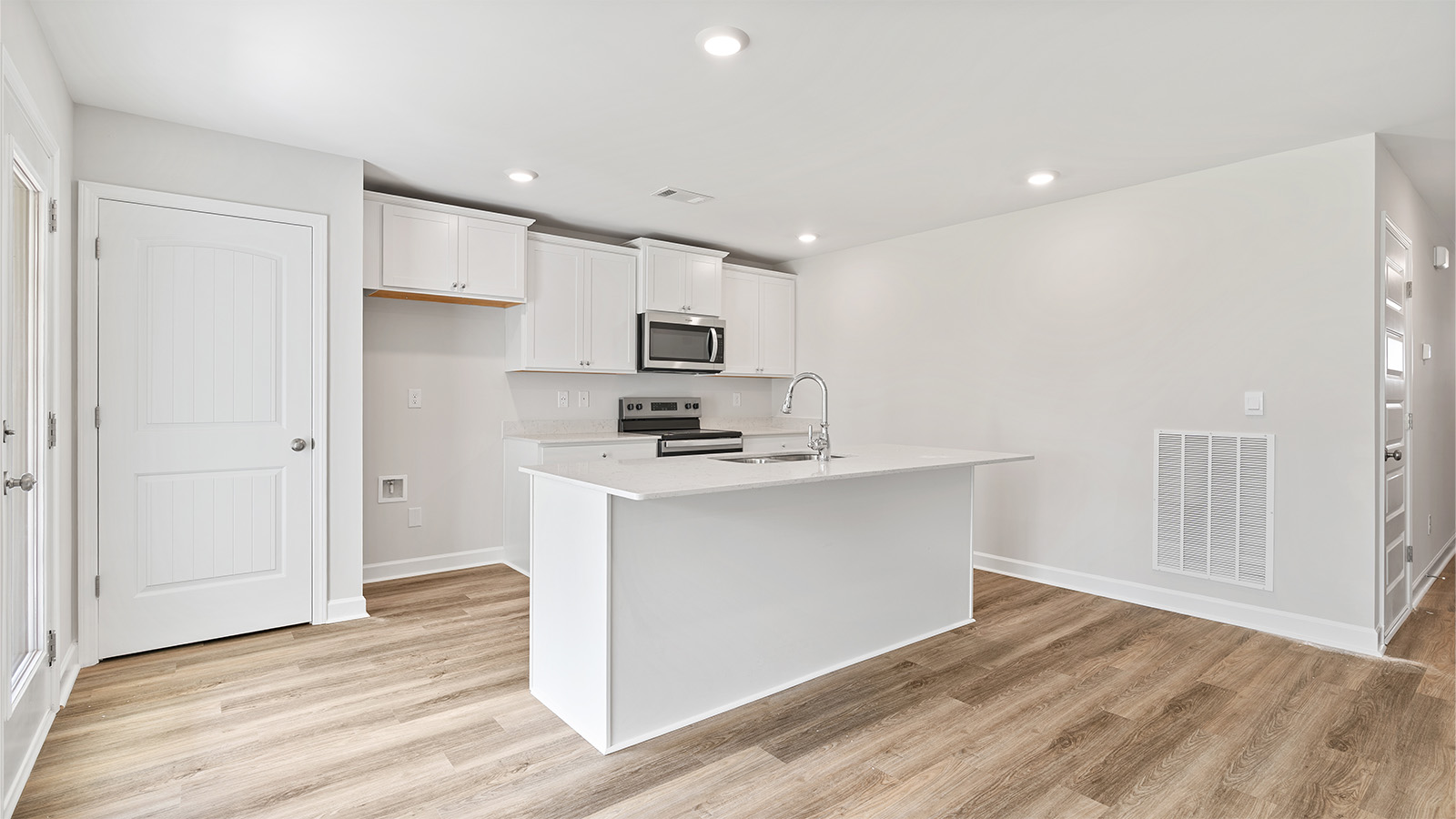 luxury vinyl plank flooring in kitchen with stainless steel appliances and Quartz countertops with soft close cabinets
