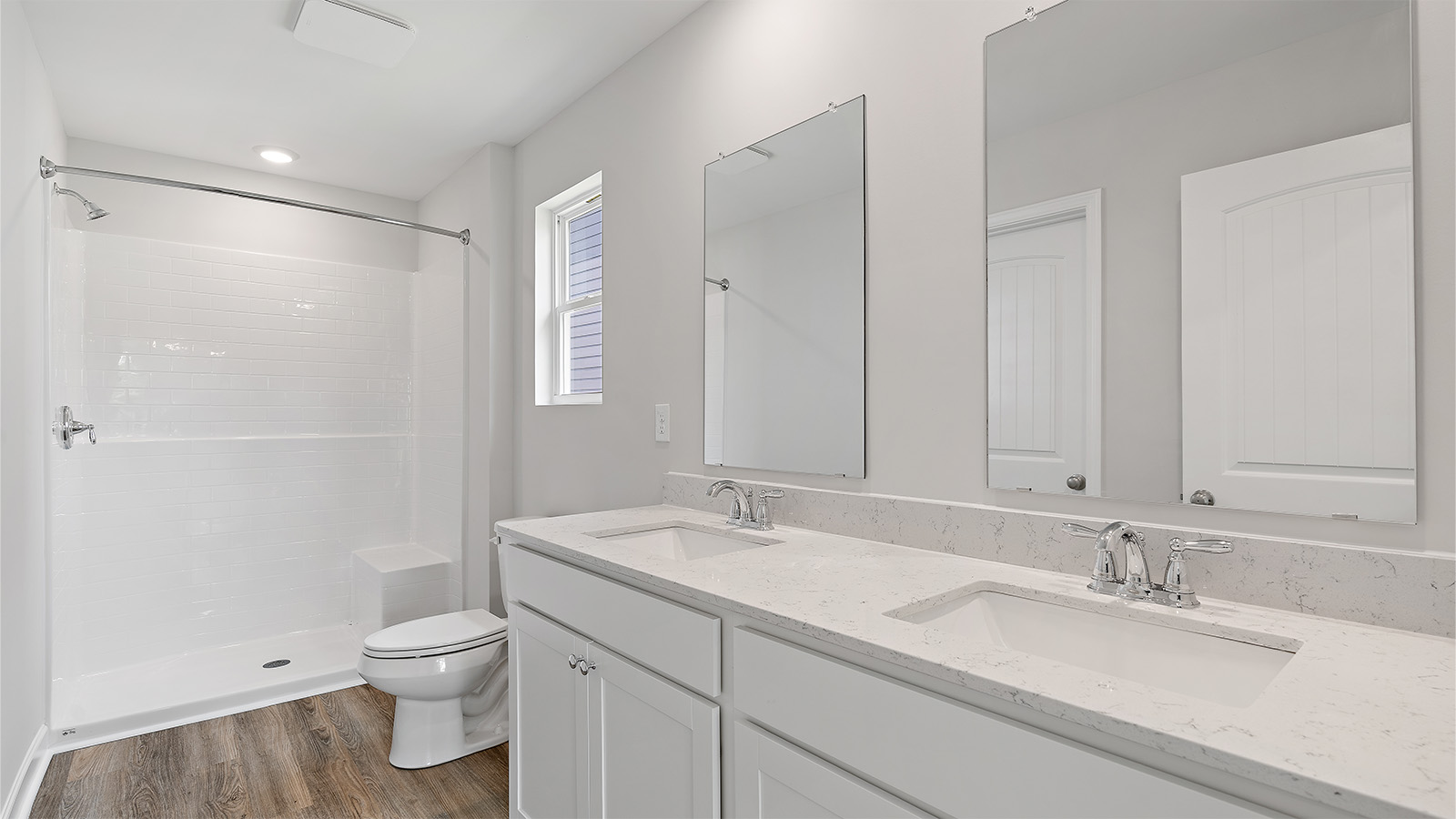 luxury vinyl plan flooring in bathrooms with quartz countertops