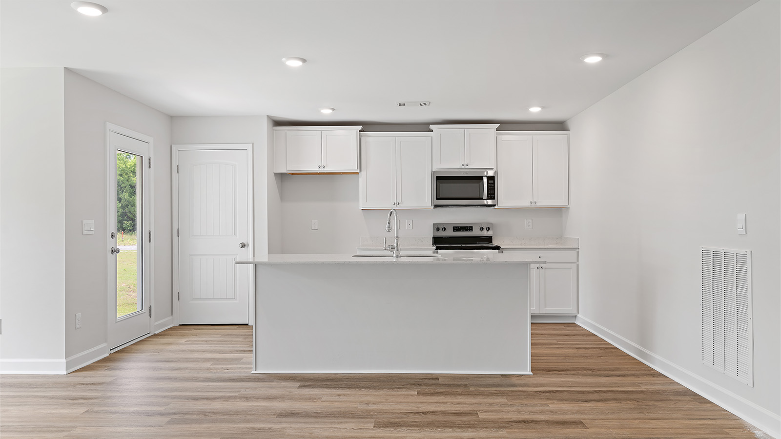 luxury vinyl plank flooring in kitchen with stainless steel appliances and Quartz countertops with soft close cabinets