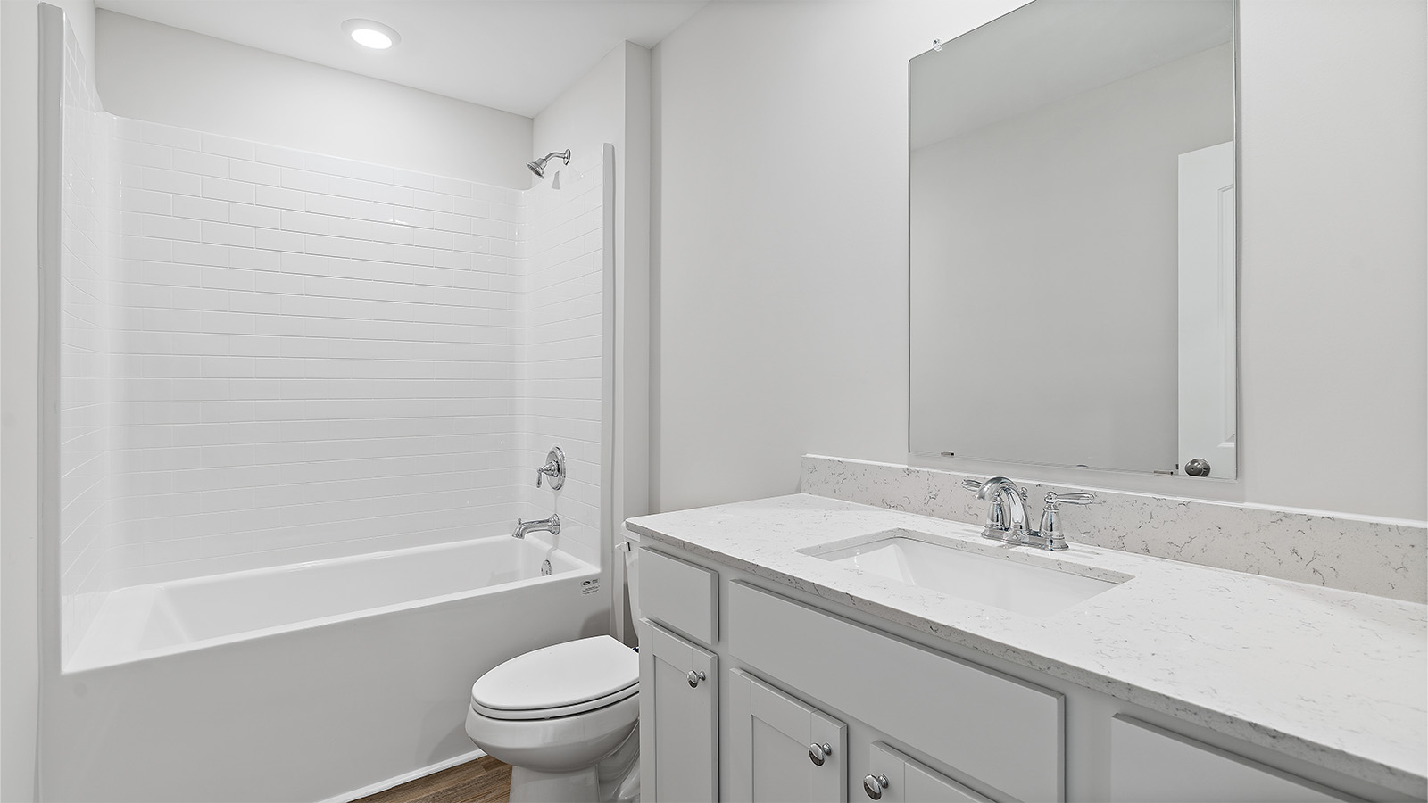 luxury vinyl plan flooring in bathrooms with quartz countertops