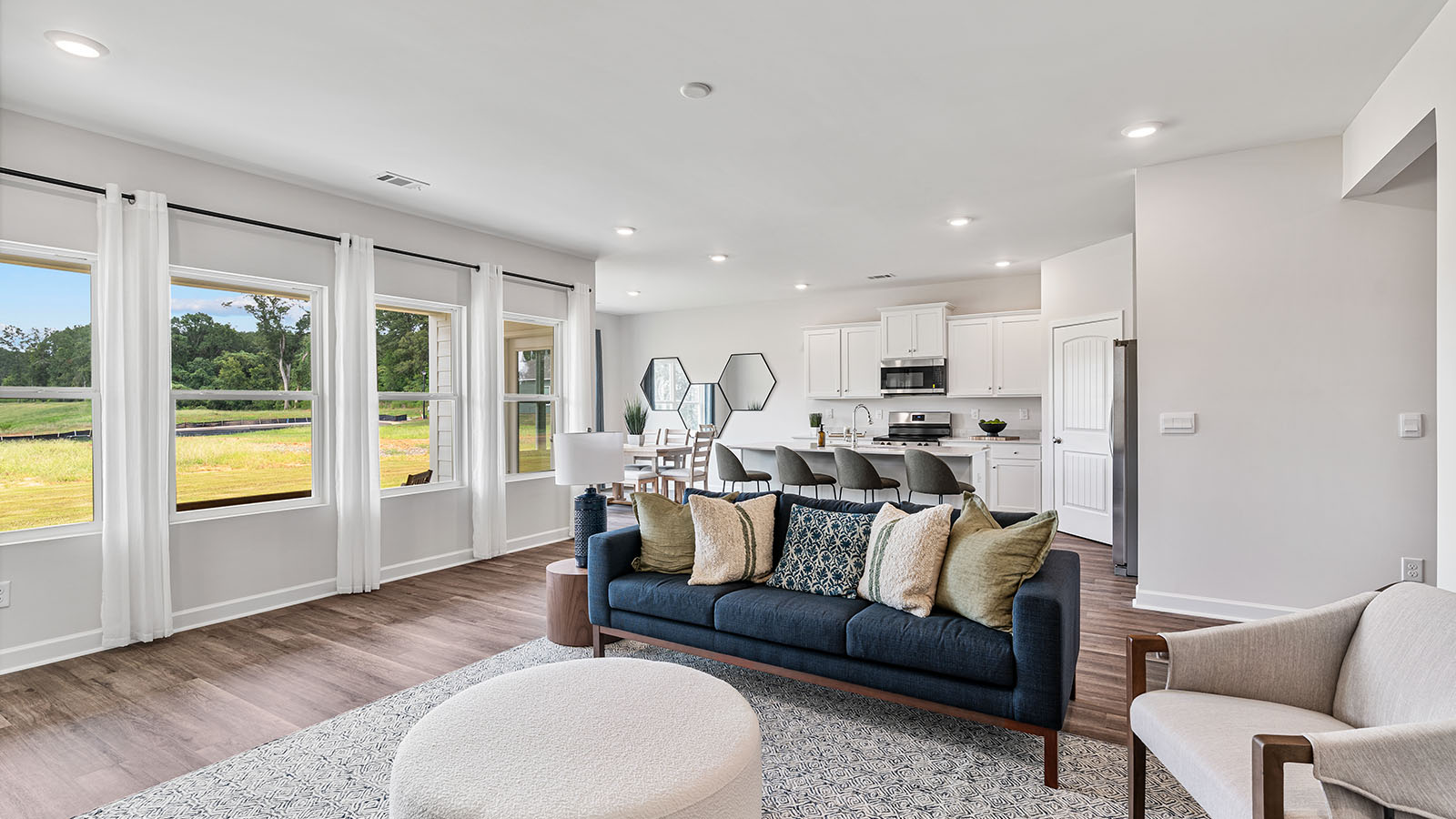 Modern living area with LVP flooring and direct connection to the kitchen.