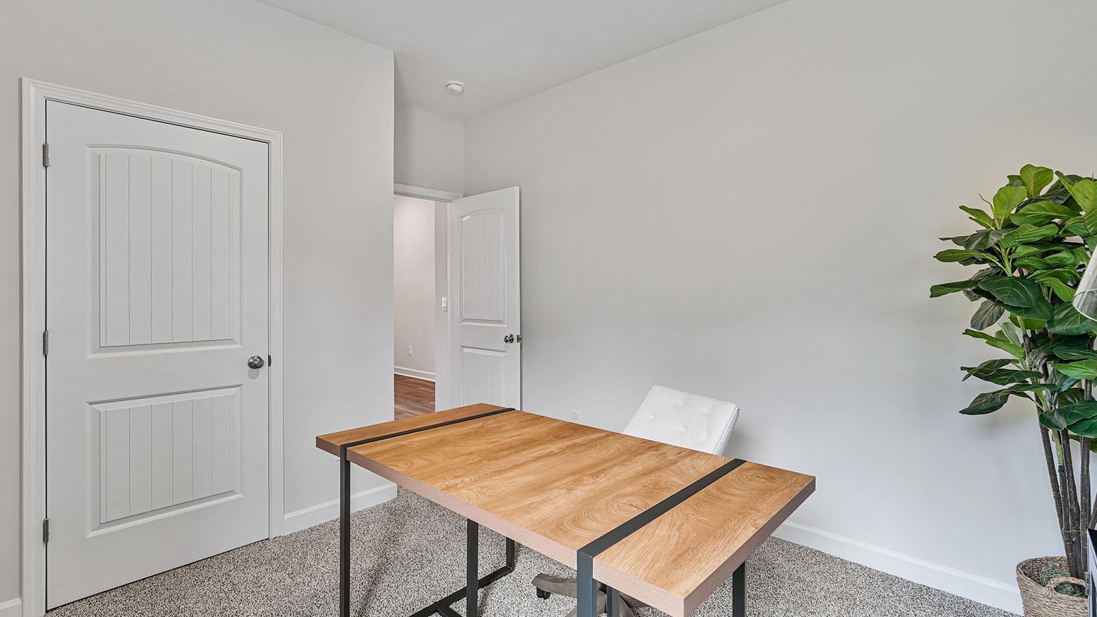 Versatile guest bedroom offering soft carpet and a functional closet.