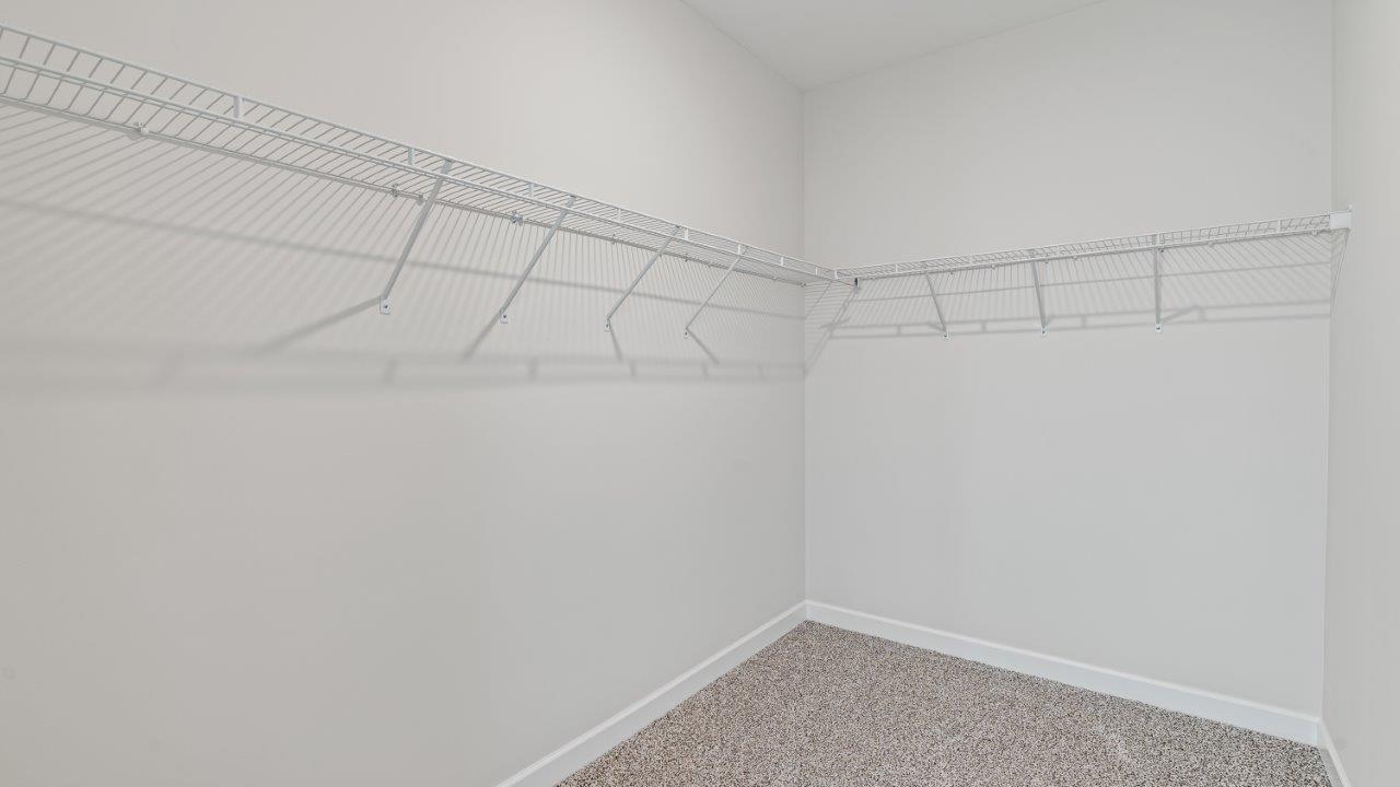 Avery floorplan space in Willow Point community owner’s bath with double vanity and walk in closet in Willow Point