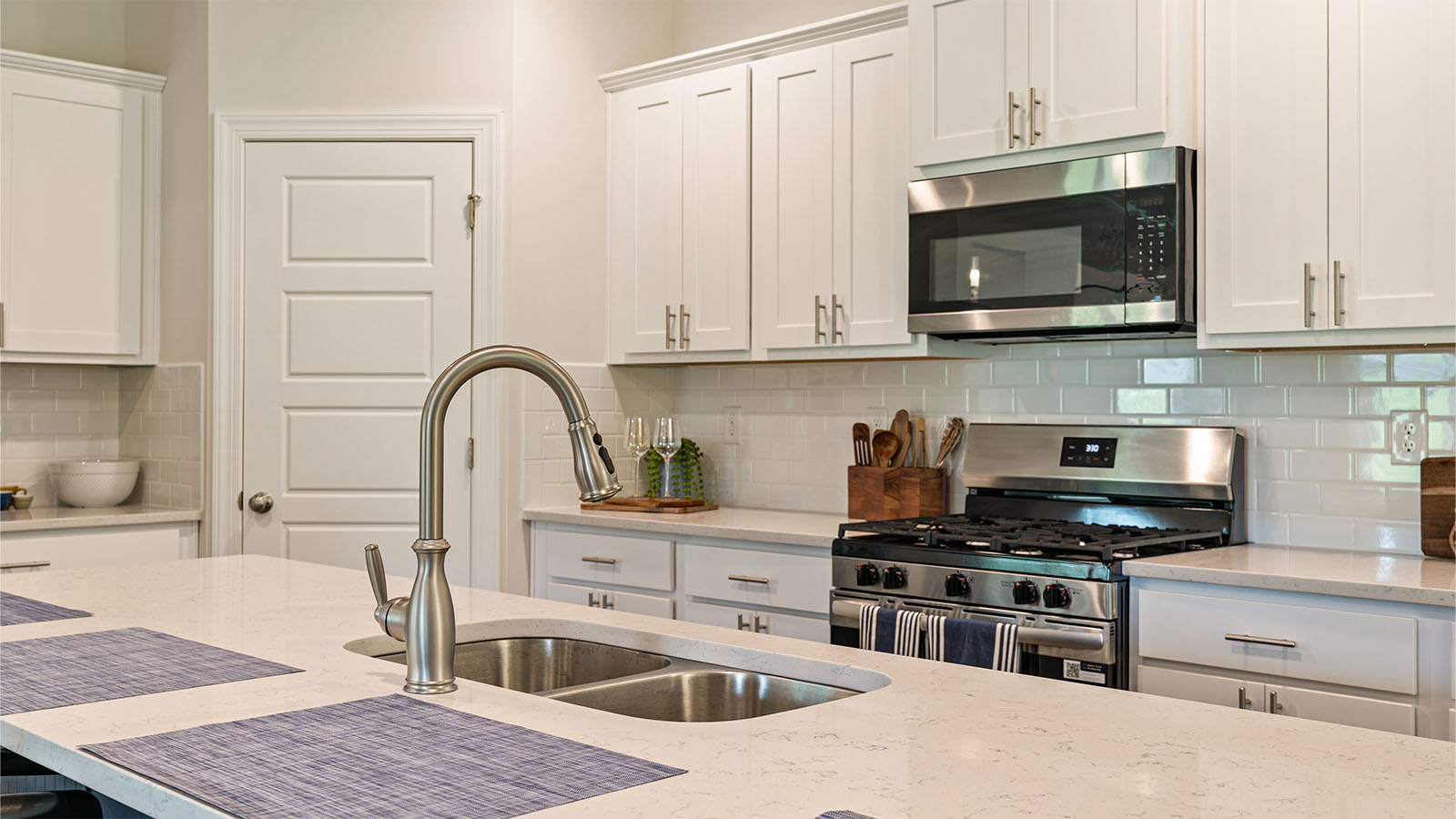The Camden floorplan kitchen with quartz countertops, soft close cabinets, and LVP flooring