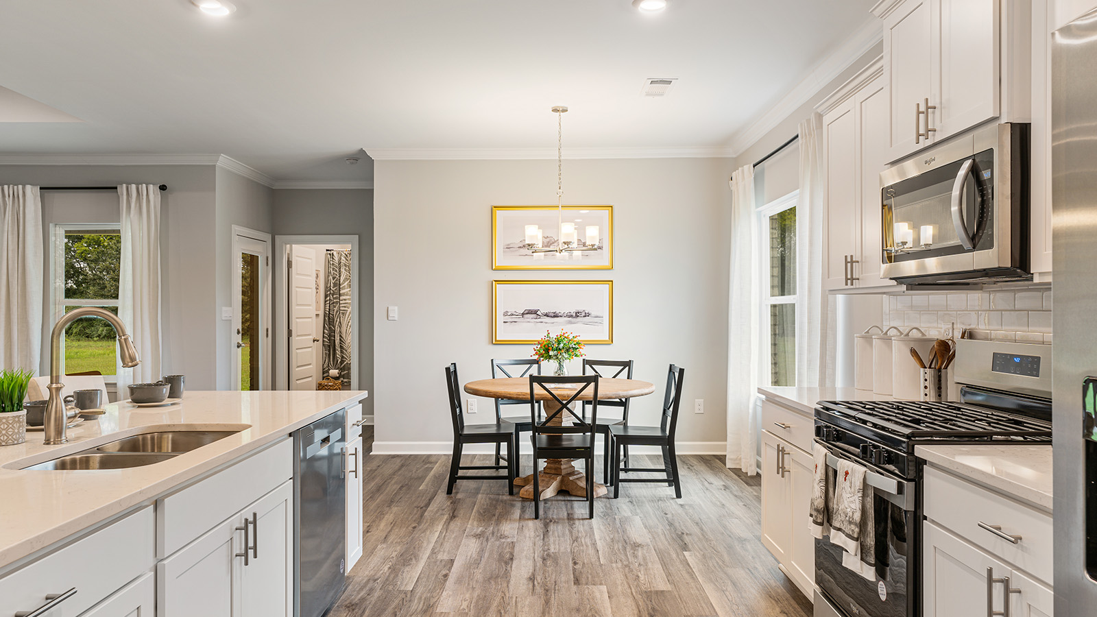 luxury vinyl plank flooring in kitchen with stainless steel appliances and Quartz countertops with soft close cabinets