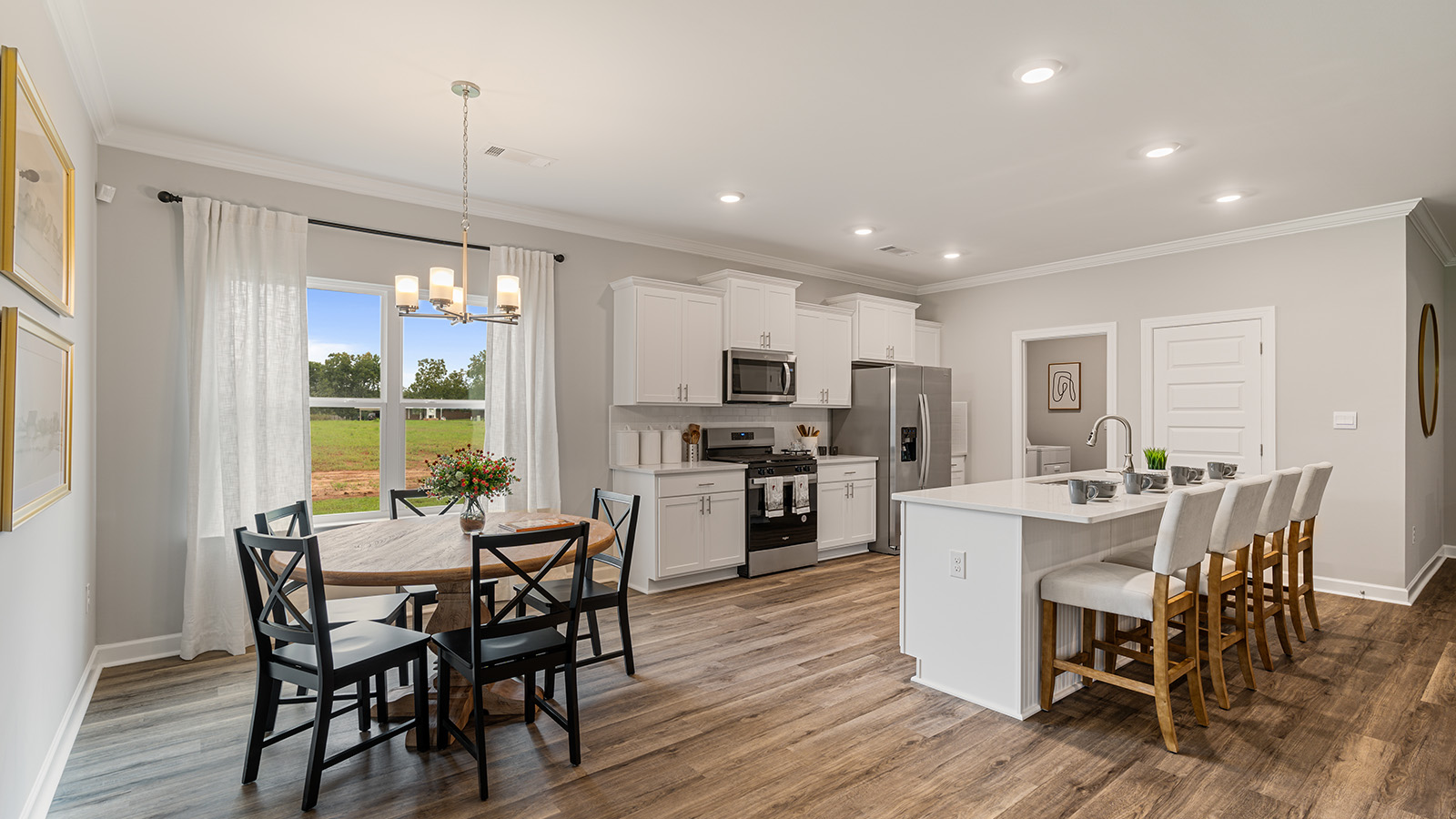 luxury vinyl plank flooring in kitchen with stainless steel appliances and Quartz countertops with soft close cabinets