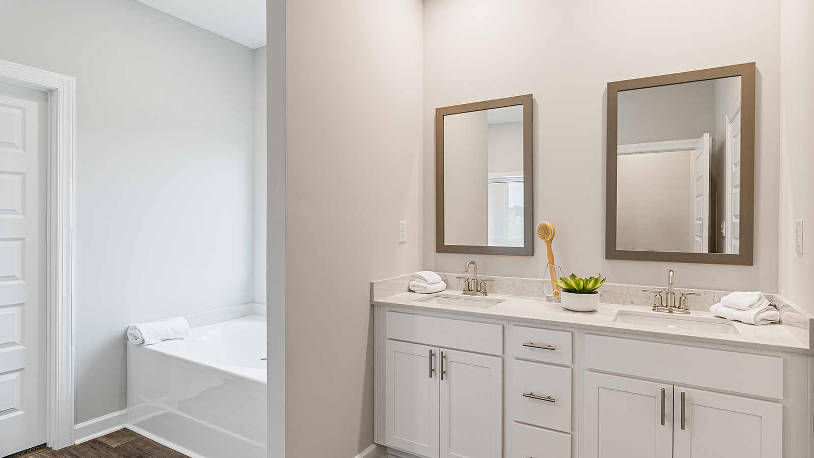 luxury vinyl plan flooring in bathrooms with quartz countertops