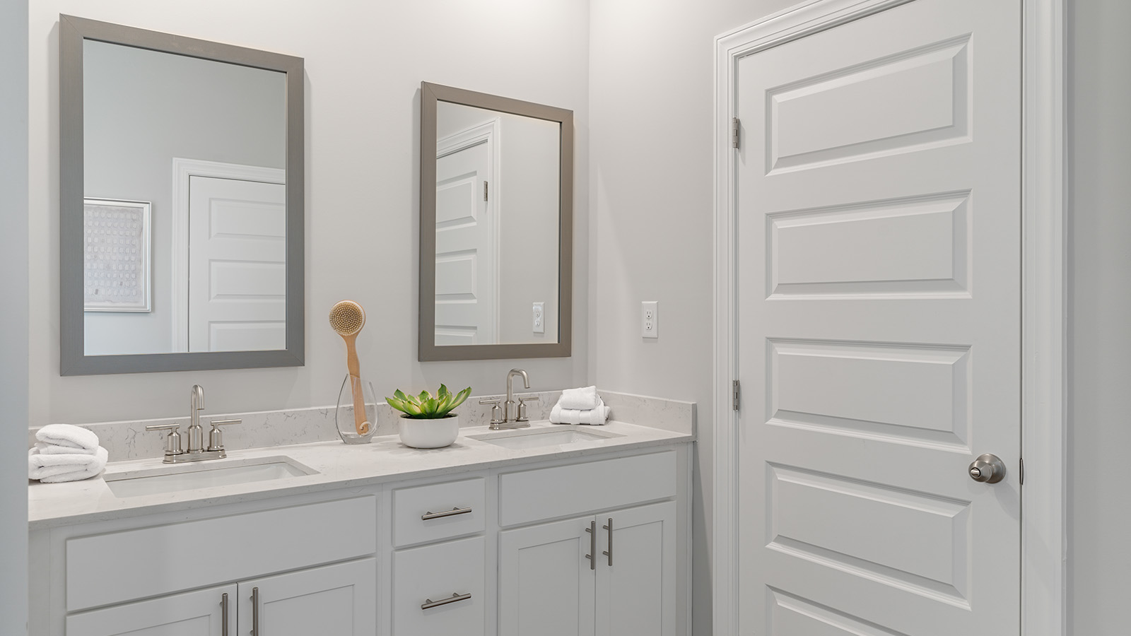 luxury vinyl plan flooring in bathrooms with quartz countertops