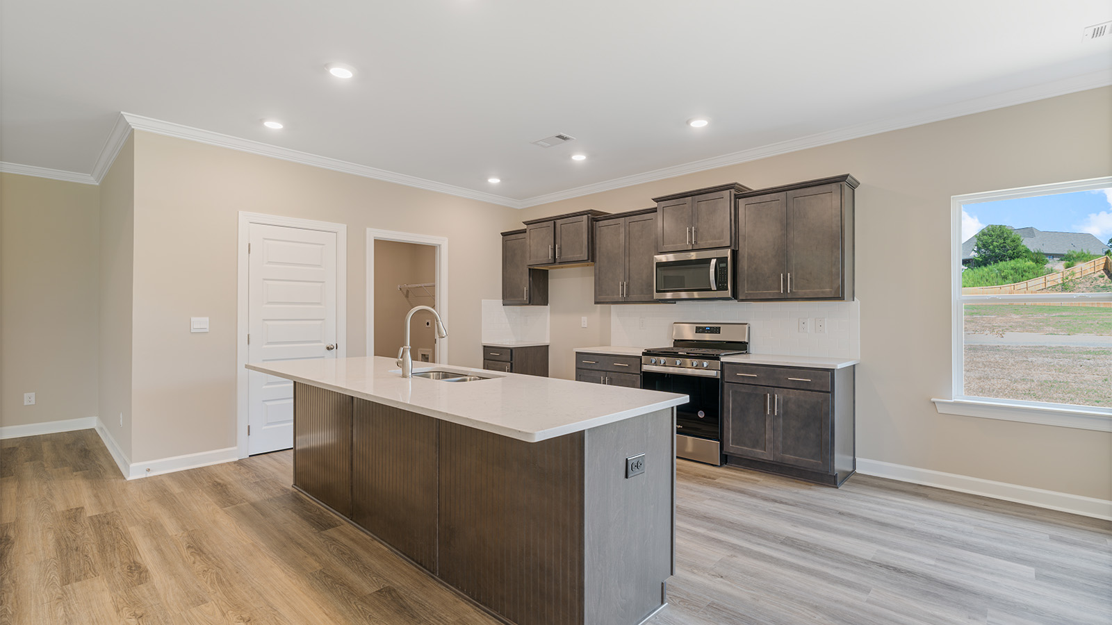 Open kitchen with island and quartz counter tops