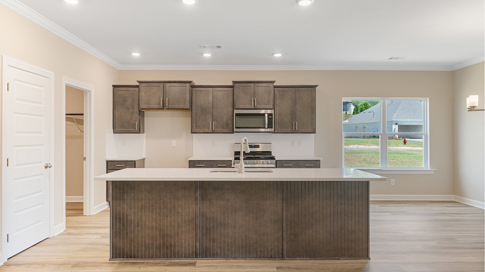 Open kitchen with island and quartz counter tops