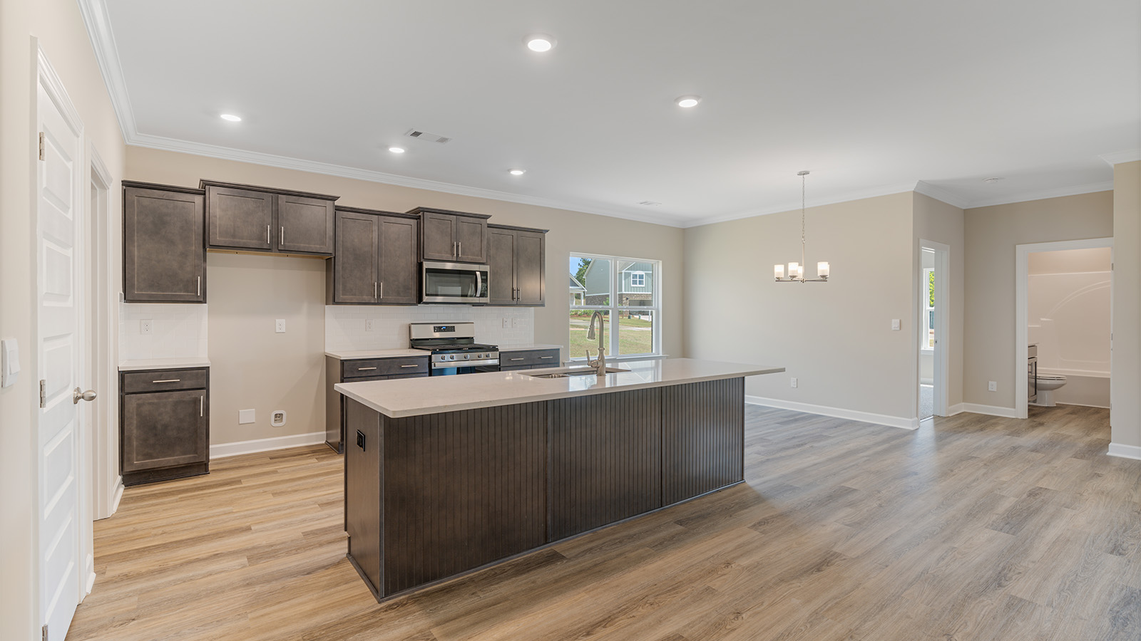 Open kitchen with island and quartz counter tops