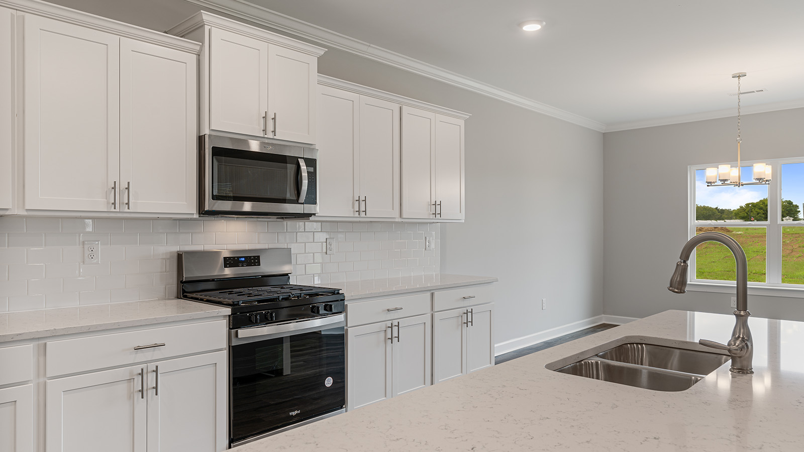 luxury vinyl plank flooring in kitchen with stainless steel appliances and Quartz countertops with soft close cabinets