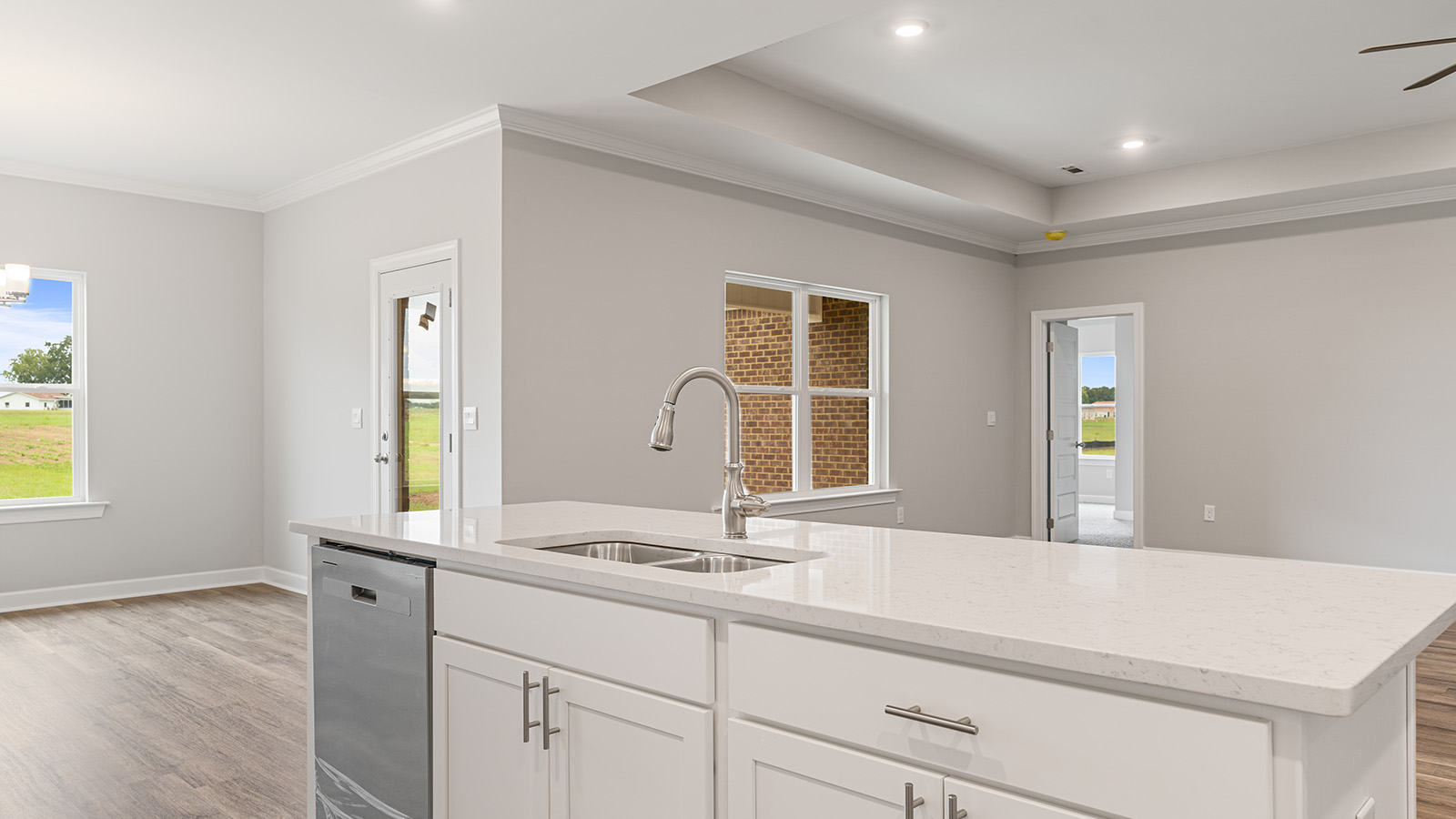 luxury vinyl plank flooring in kitchen with stainless steel appliances and Quartz countertops with soft close cabinets