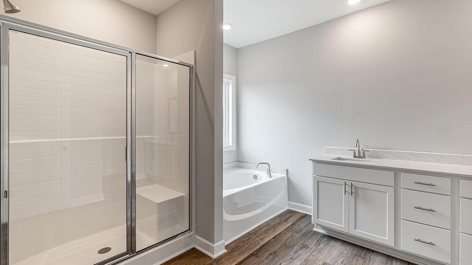 luxury vinyl plan flooring in bathrooms with quartz countertops
