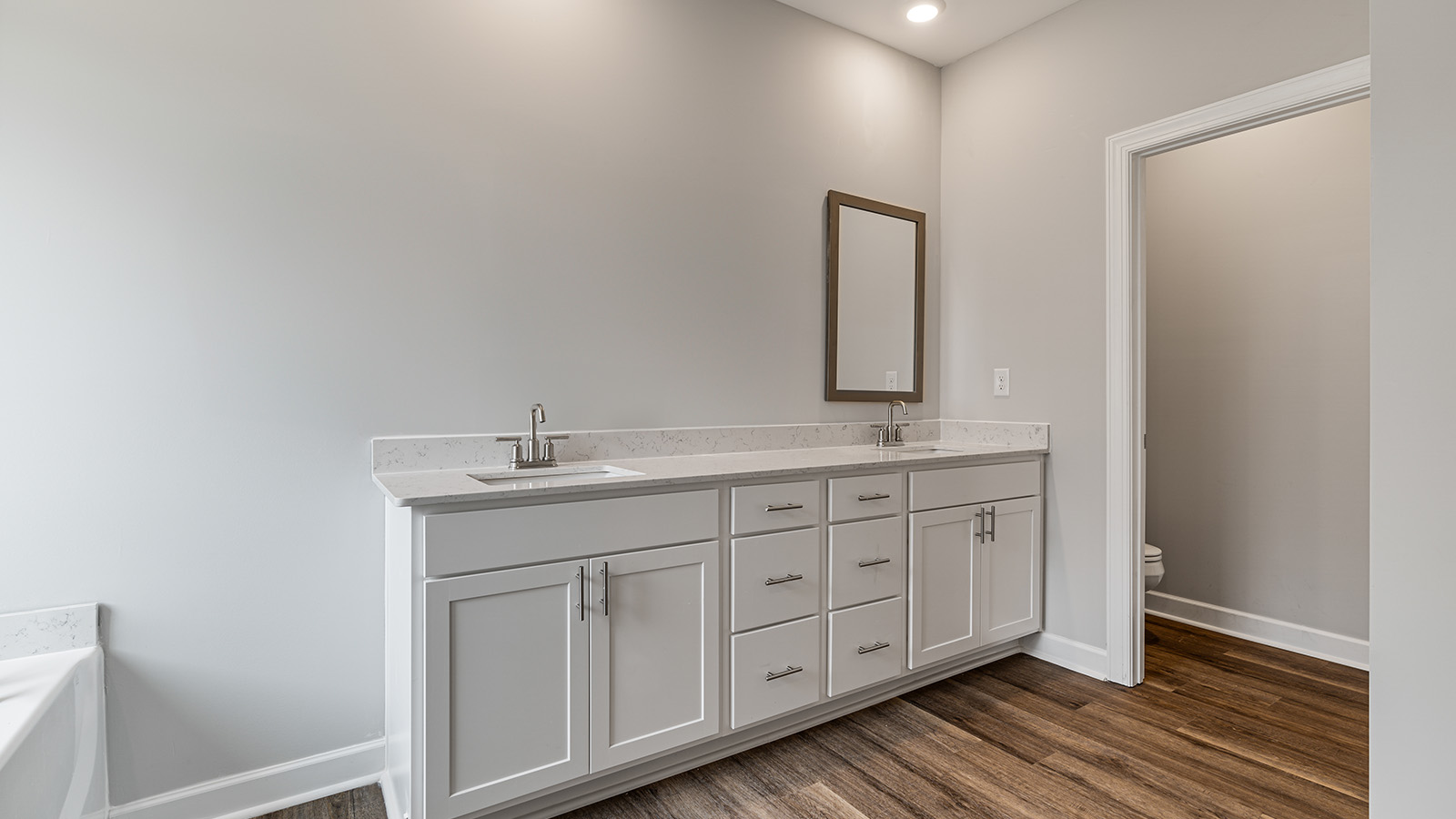 luxury vinyl plan flooring in bathrooms with quartz countertops