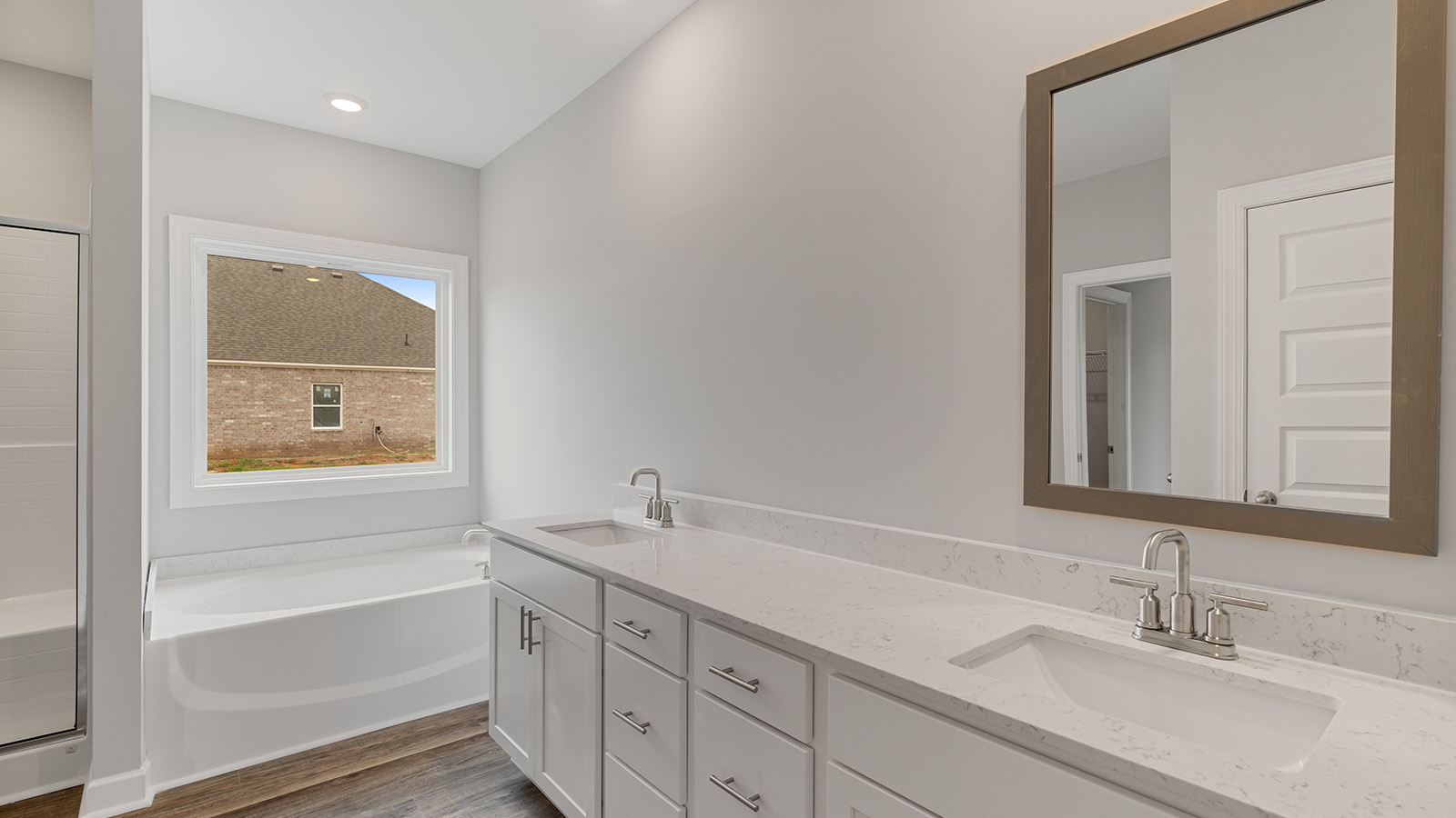 luxury vinyl plan flooring in bathrooms with quartz countertops