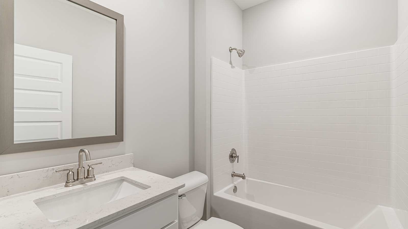 luxury vinyl plan flooring in bathrooms with quartz countertops