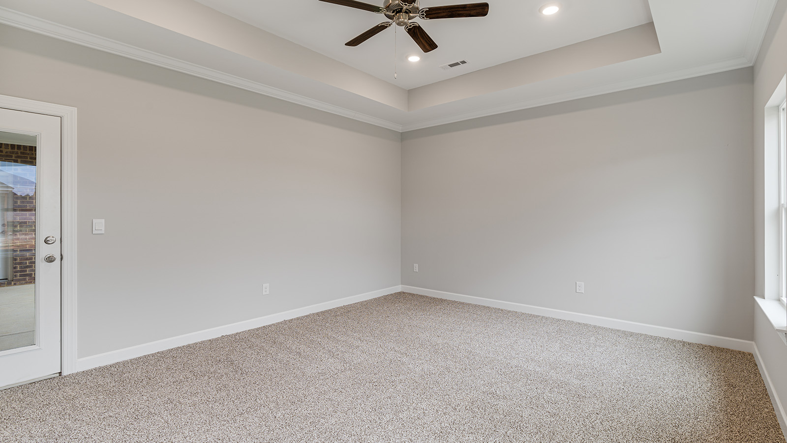 The Hawthorne floorplan bedroom with carpet and a ceiling fan