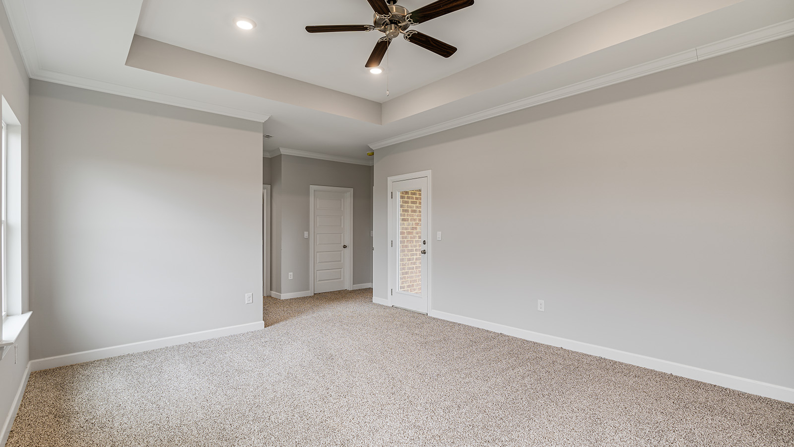 The Hawthorne floorplan bedroom with carpet and a ceiling fan