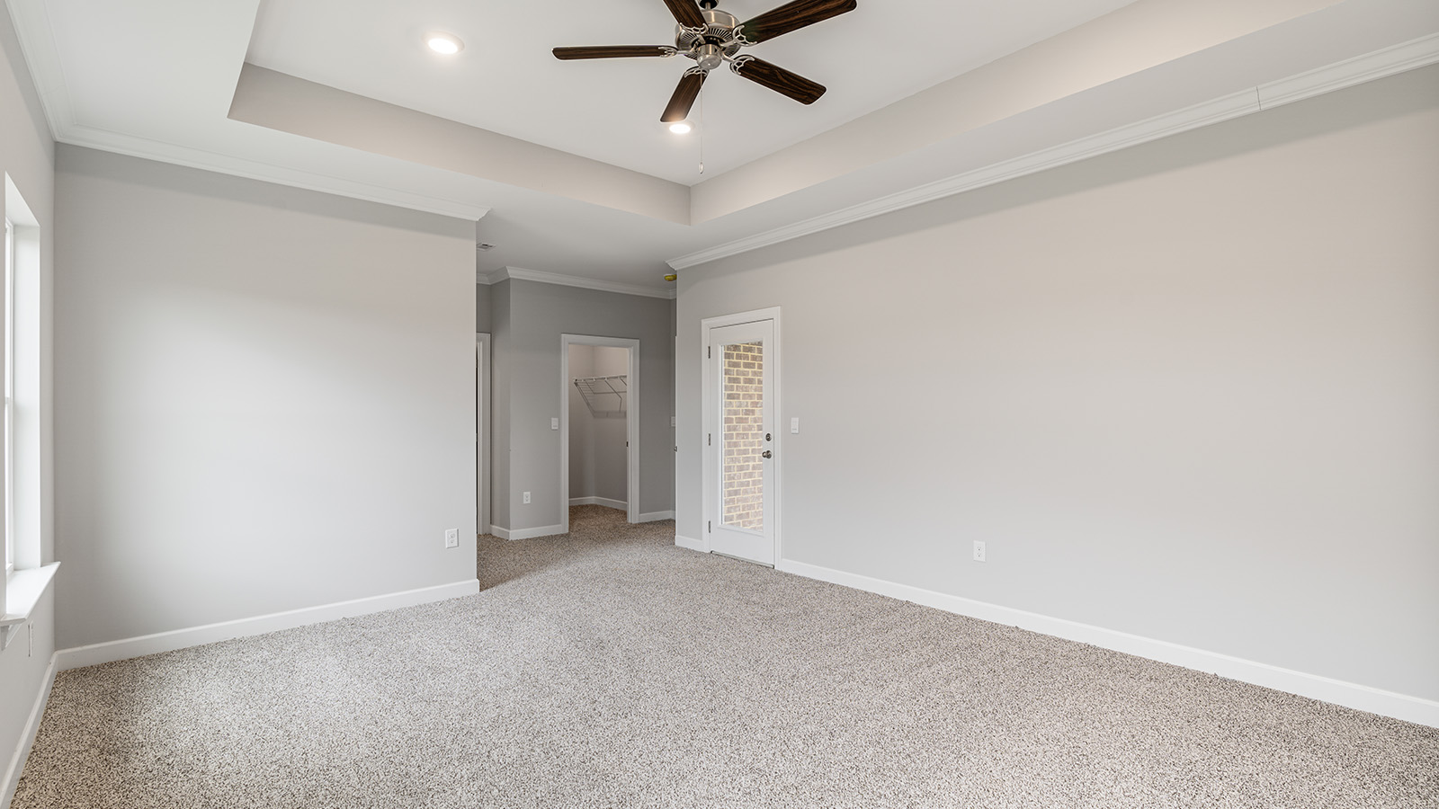 The Hawthorne floorplan bedroom with carpet and a ceiling fan
