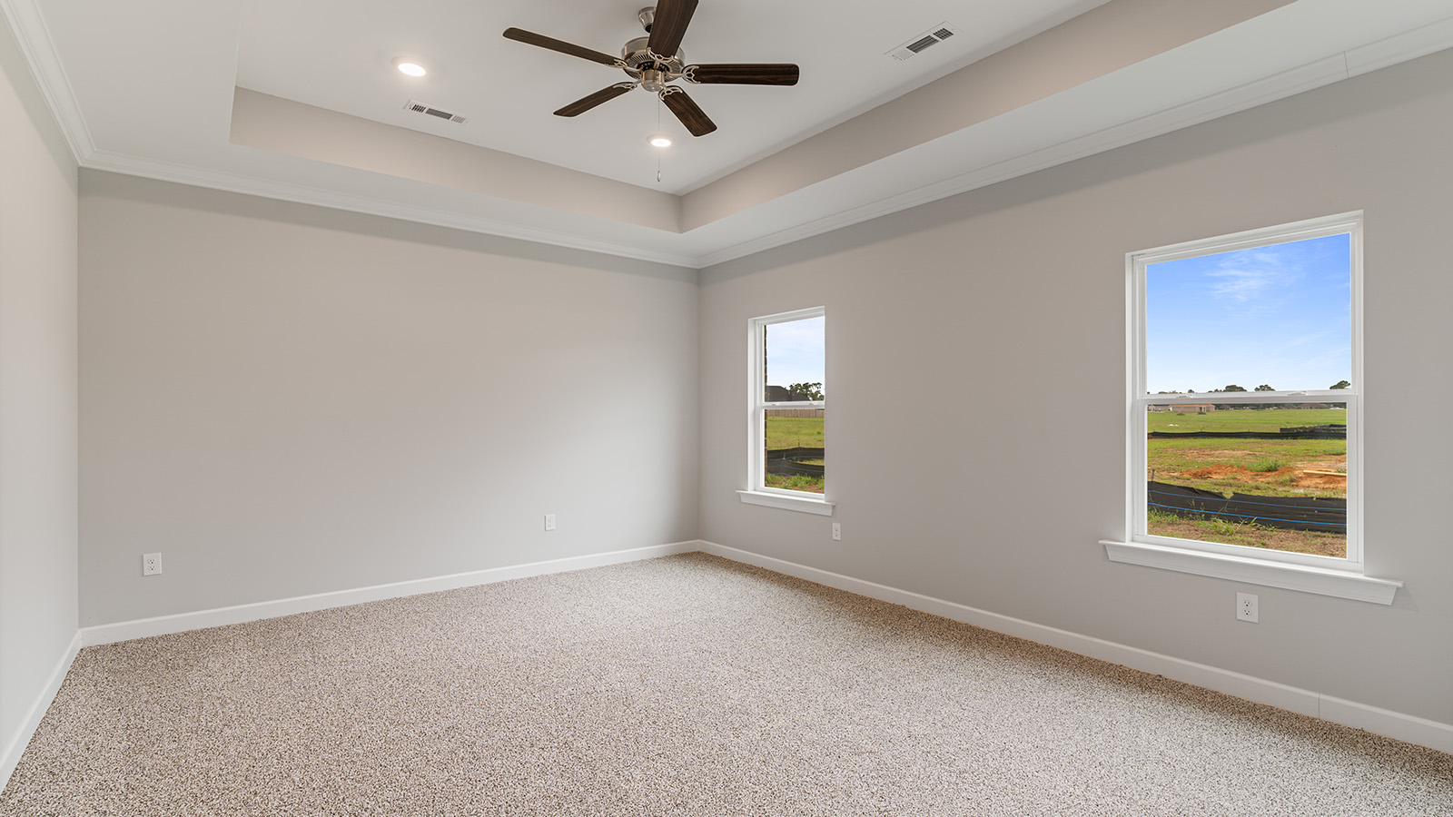 The Hawthorne floorplan bedroom with carpet and a ceiling fan