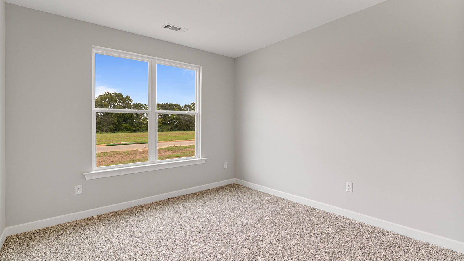 The Hawthorne floorplan bedroom with carpet and a ceiling fan