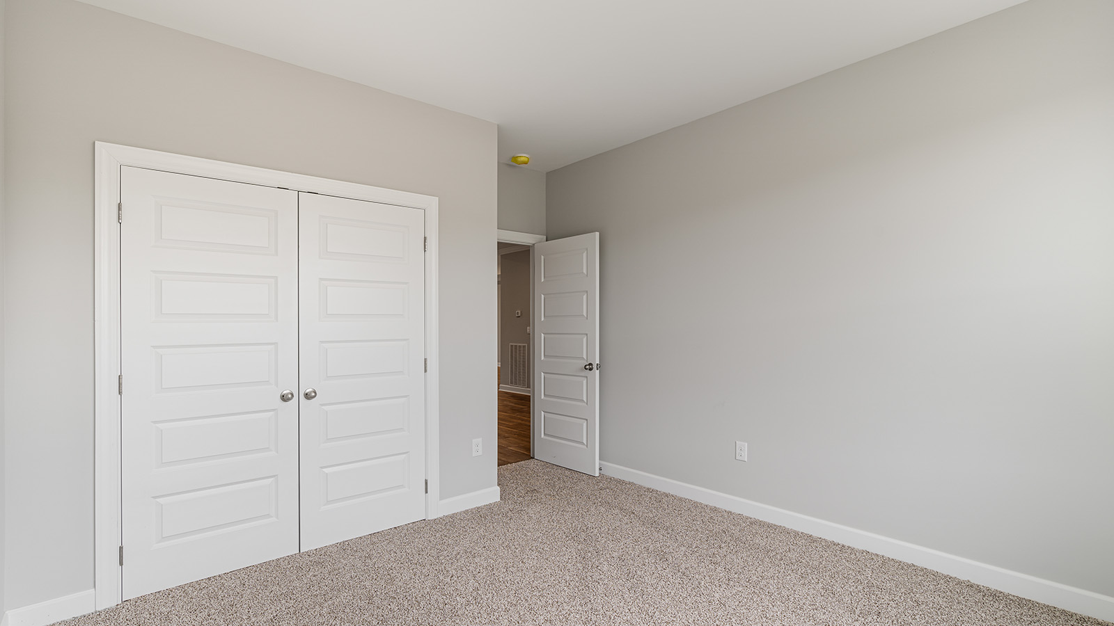 The Hawthorne floorplan bedroom with carpet and a ceiling fan